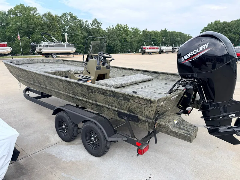 Slide: The Image of The image shows a Tracker Grizzly 2072 CC boat on a trailer with a Mercury outboard motor. - 6