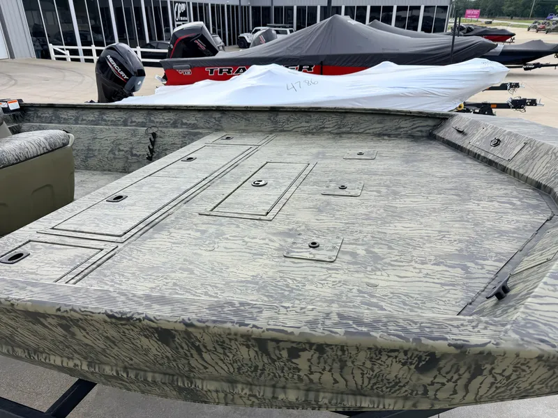 Slide: The Image of The image shows the deck of a Tracker Grizzly 2072 CC boat with a camouflage pattern. - 11