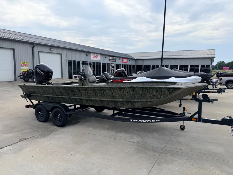 The Image of A 2027 Tracker Grizzly 2072 CC on a trailer in front of a building. - 1
