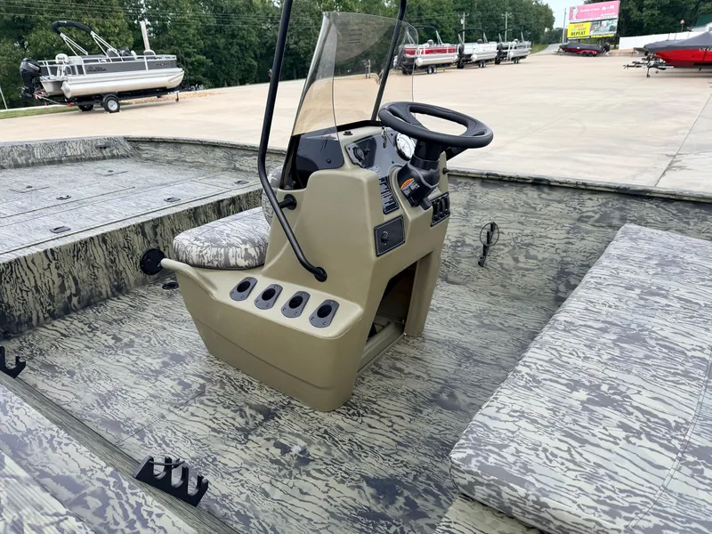 Slide: The Image of The image shows the cockpit of a 2027 Tracker Grizzly 2072 CC with a rugged design. - 8