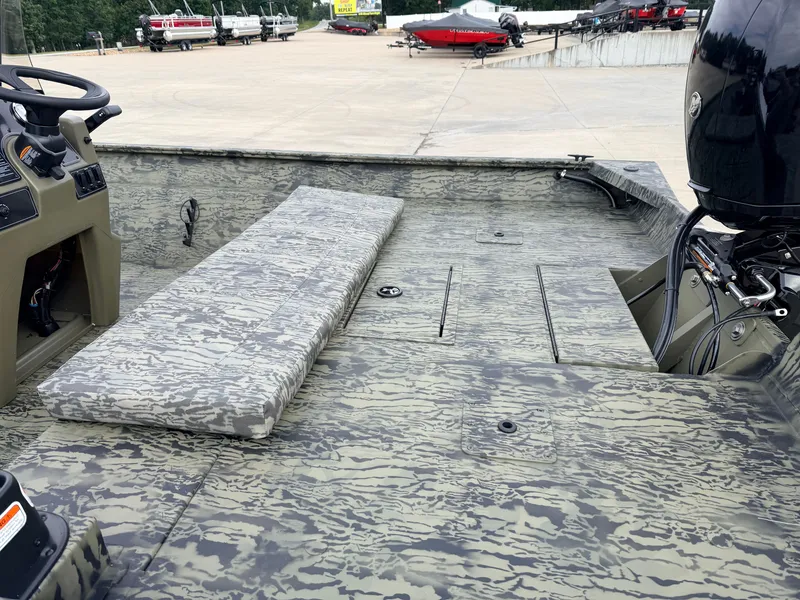 Slide: The Image of The image shows the deck of a Tracker Grizzly 2072 CC boat with camouflage pattern and an outboard motor. - 7
