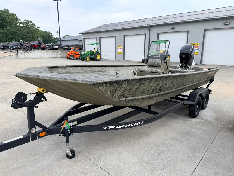 Slide: The Image of A 2027 Tracker Grizzly 2072 CC on a trailer. It features a rugged design and an outboard motor. - 10