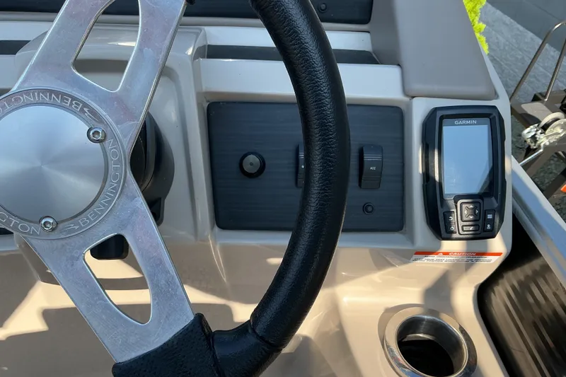 Slide: The Image of 2019 Bennington 22 SSLX boat dashboard with steering wheel and Garmin device. - 11
