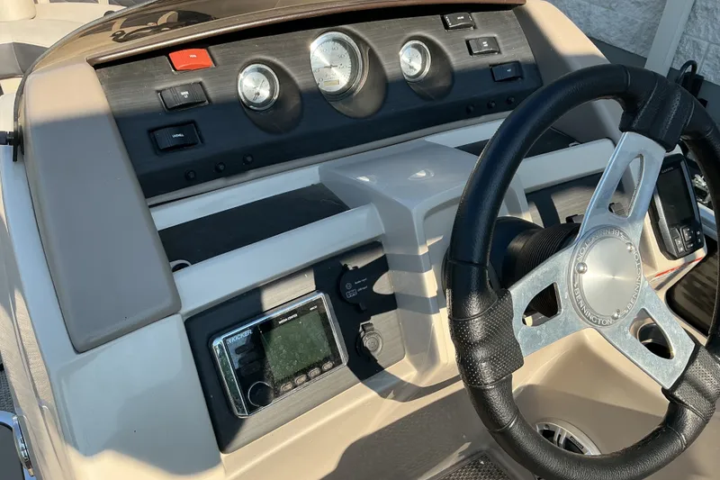 Slide: The Image of 2019 Bennington 22 SSLX boat dashboard with steering wheel and control panel. - 10