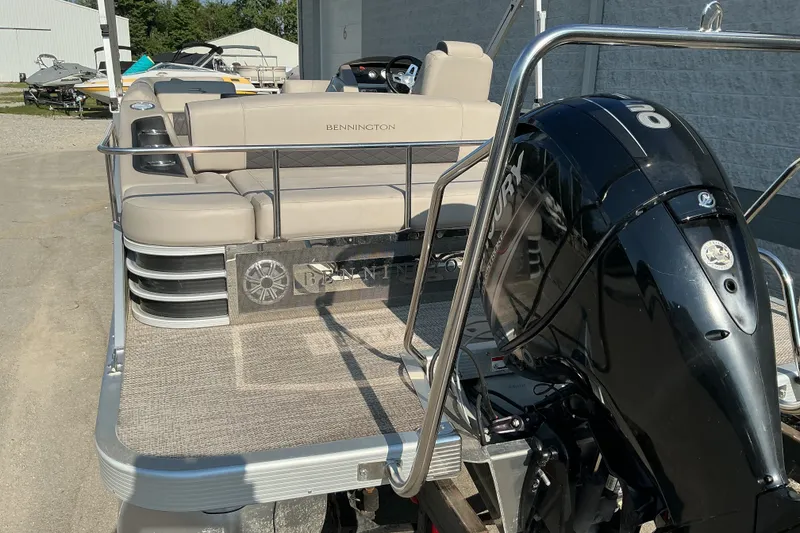 Slide: The Image of 2019 Bennington 22 SSLX pontoon boat with Mercury outboard motor, docked outdoors. - 5