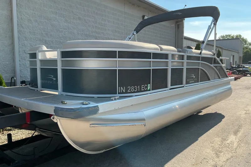 The Image of 2019 Bennington 22 SSLX pontoon boat with canopy, parked outdoors on a trailer. - 1