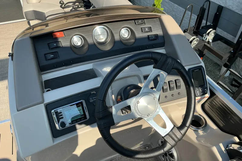 Slide: The Image of 2019 Bennington 22 SSLX boat dashboard with steering wheel and control panel. - 9