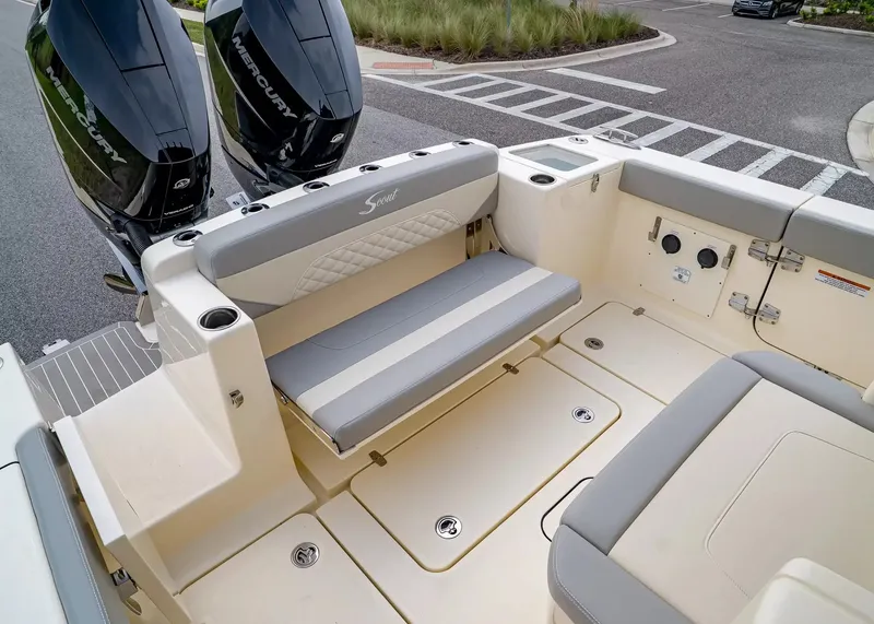 Slide: The Image of The image shows the stern of a Scout 330 LXF boat with two Mercury engines and a bench seat. - 7