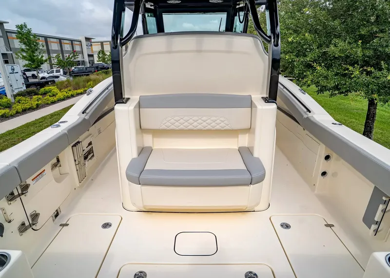 Slide: The Image of The image shows the cockpit of a Scout 330 LXF boat with gray and white seating. - 12