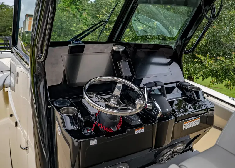 Slide: The Image of The image shows the helm of a Scout 330 LXF boat with modern instruments and steering wheel. - 20
