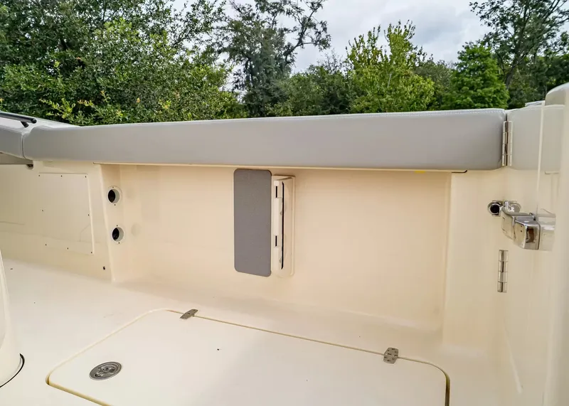 Slide: The Image of The image shows the deck of a 2027 Scout 330 LXF boat with gray upholstery. - 16