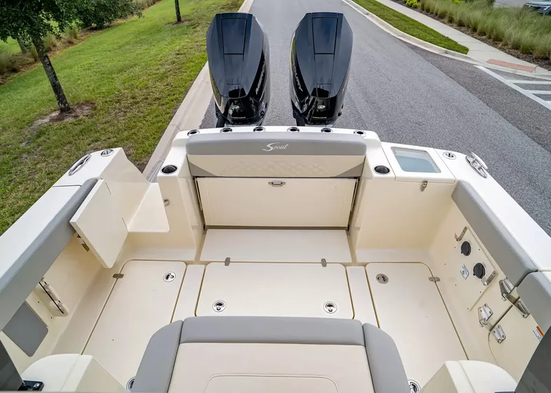 Slide: The Image of The image shows the stern of a Scout 330 LXF boat with two outboard engines. - 5