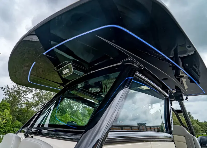 Slide: The Image of The image shows the hardtop of a Scout 330 LXF boat with blue LED lighting. - 26