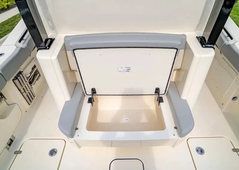 Slide: The Image of The image shows the seating area of a Scout 330 LXF boat with integrated storage. - 13