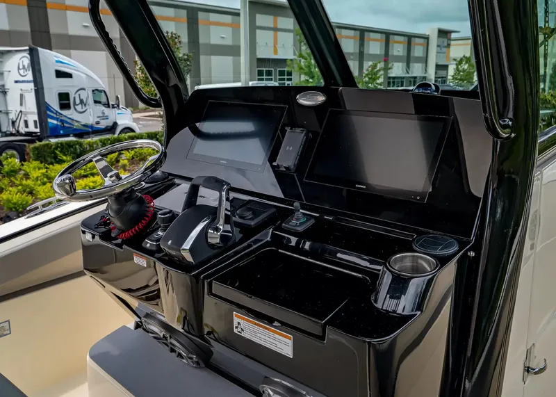 Slide: The Image of The image shows the cockpit of a Scout 330 LXF boat with modern controls and screens. - 21