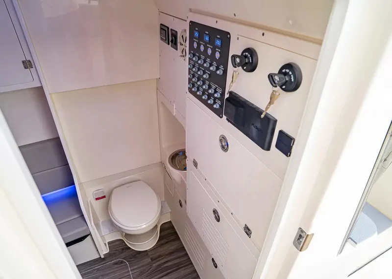 Slide: The Image of Interior of a 2027 Scout 330 LXF featuring a toilet and control panel. - 29