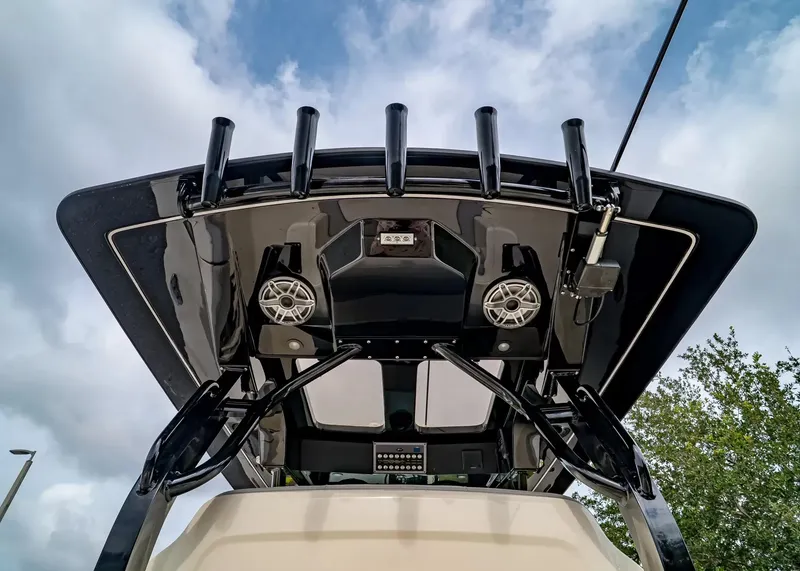 Slide: The Image of The image shows the roof of a Scout 330 LXF boat with speakers and fishing rod holders. - 17