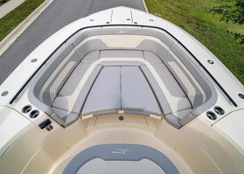 Slide: The Image of The image shows the bow of a Scout 330 LXF boat with sleek gray upholstery. - 37