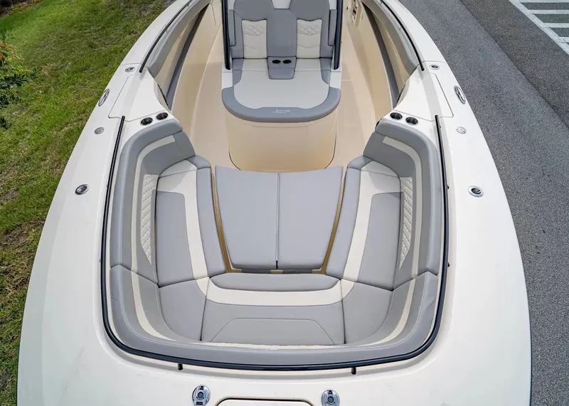 Slide: The Image of The image shows the bow of a Scout 330 LXF boat with sleek gray upholstery. - 31