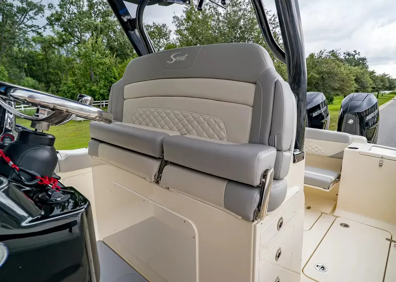 Slide: The Image of The image shows the cockpit of a Scout 330 LXF boat with luxurious seating and helm console. - 24