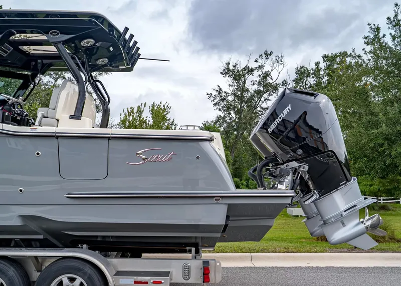 Slide: The Image of A 2027 Scout 330 LXF boat on a trailer, featuring a Mercury outboard motor. - 3