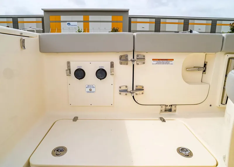 Slide: The Image of The image shows the stern of a Scout 330 LXF boat with storage and connections. - 14