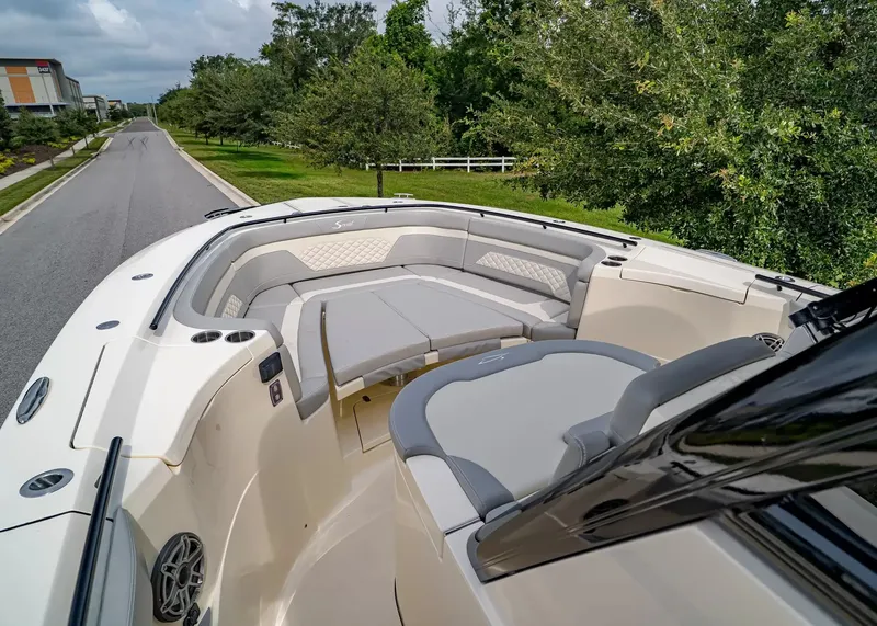Slide: The Image of The image shows the bow of a Scout 330 LXF boat with gray upholstery and seating. - 30
