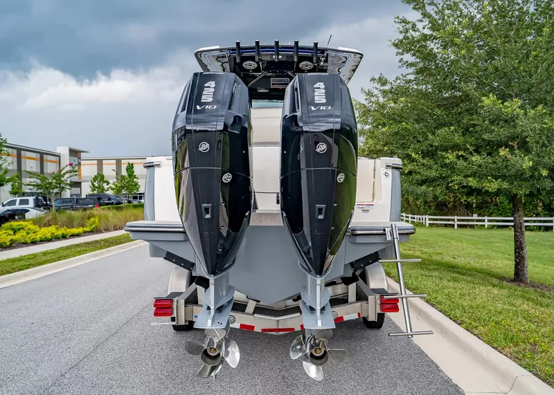 Slide: The Image of The image shows the rear of a Scout 330 LXF boat with two powerful outboard engines. - 4