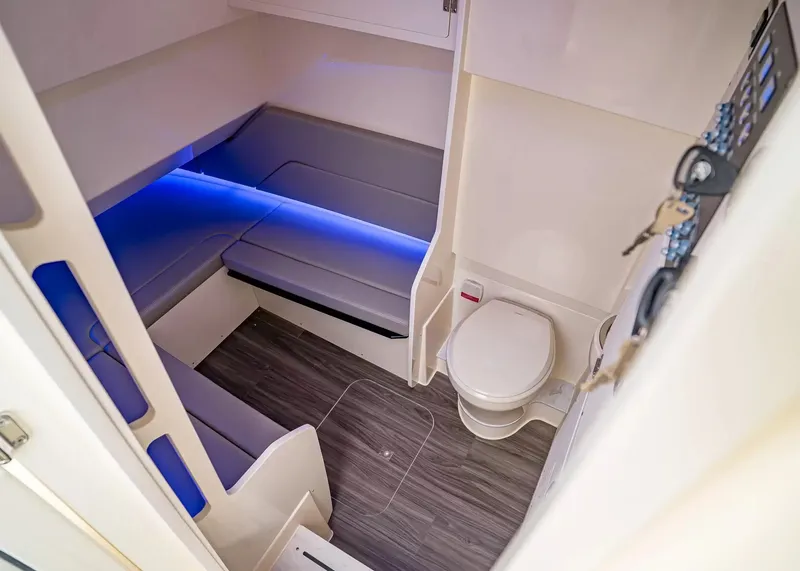 Slide: The Image of Interior of a 2027 Scout 330 LXF with seating area and toilet, modern and well-lit. - 27