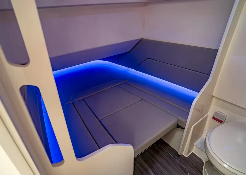 Slide: The Image of The 2027 Scout 330 LXF cabin features a modern, illuminated berth and a toilet. - 28