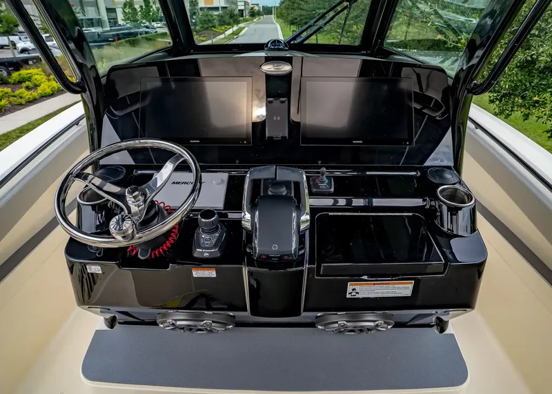 Slide: The Image of The 2027 Scout 330 LXF cockpit features a modern helm with two large screens. - 19