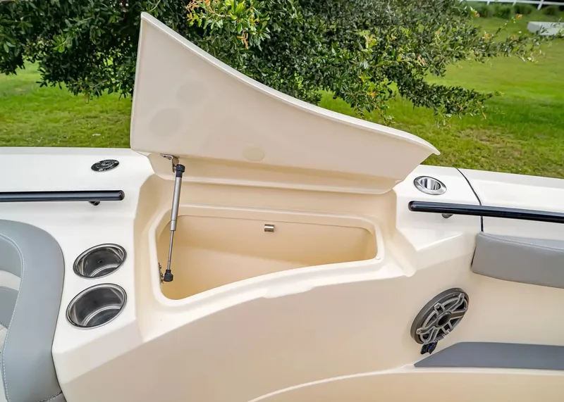 Slide: The Image of The image shows a storage compartment on a 2027 Scout 330 LXF boat. - 35