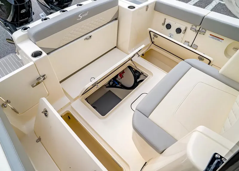 Slide: The Image of The image shows the cockpit of a 2027 Scout 330 LXF boat with storage and seating. - 9