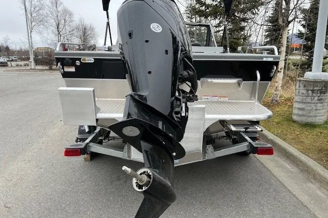 Slide: The Image of 2024 Spartan 185 Astoria boat with outboard motor on trailer, parked outdoors. - 3