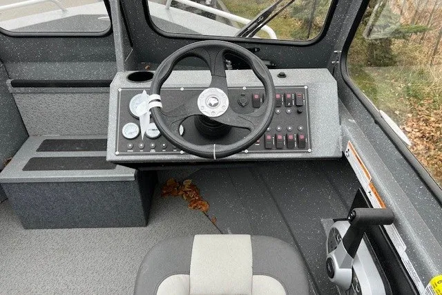 Slide: The Image of 2024 Spartan 185 Astoria boat cockpit with steering wheel and control panel. - 4