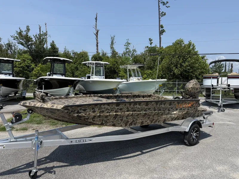 The Image of Excel Viper F4 1751 on aluminum trailer, camo design, parked outdoors. - 1
