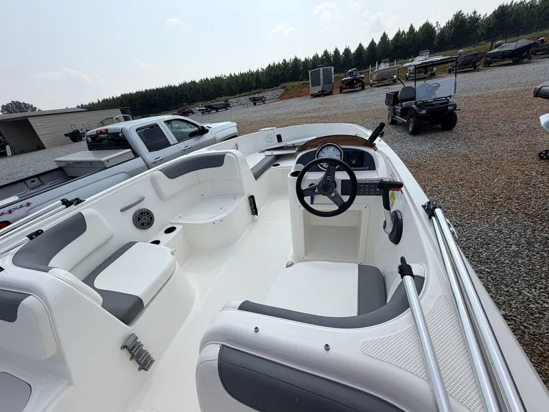 Slide: The Image of The image shows a 2018 Bayliner 180 Element XL boat. It features white seating and a steering wheel. - 14