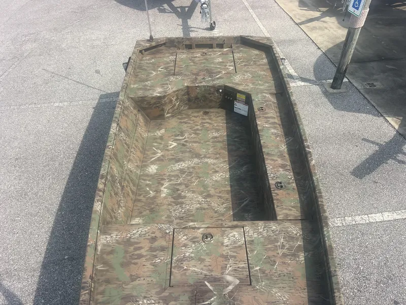 Slide: The Image of A rugged boat with camouflage pattern, suitable for hunting or fishing, is parked on a lot. - 4