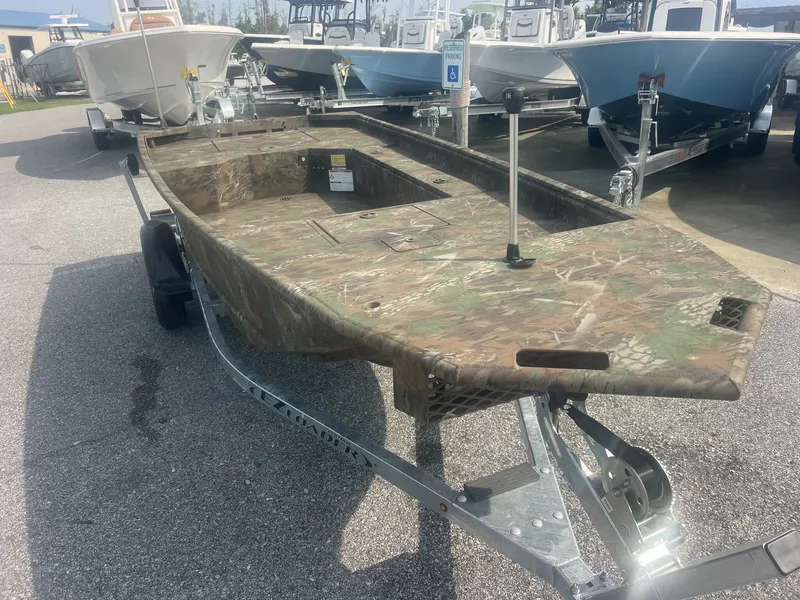 Slide: The Image of A G3 Gator Tough 15DK-40HP YAMAHA boat with camouflage pattern on a trailer. - 2
