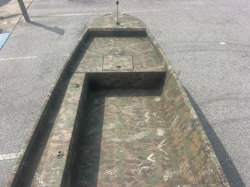Slide: The Image of The image shows a G3 Gator Tough 15DK boat with camouflage pattern, parked on a lot. - 5