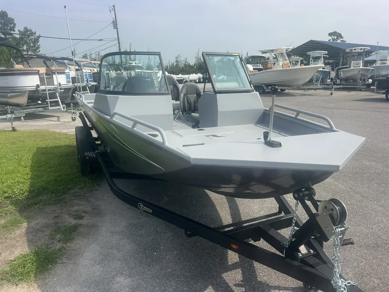 Slide: The Image of The image shows a 2027 G3 Sportsman 2100-CATFISH boat on a trailer in a marina area. - 2