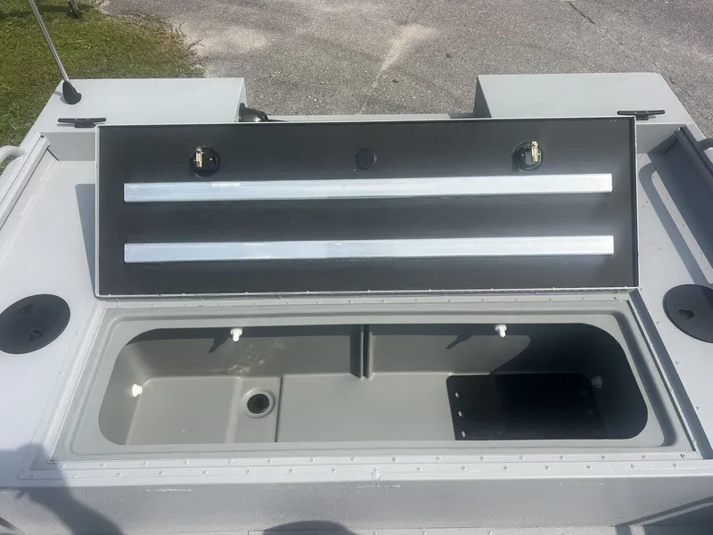 Slide: The Image of The image shows an open storage compartment on a G3 Sportsman 2100-CATFISH boat. - 4
