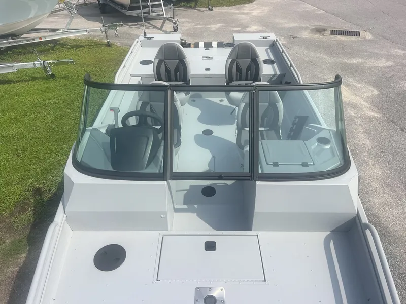Slide: The Image of The image shows a modern boat with two seats and a windshield, parked on a lot. - 6