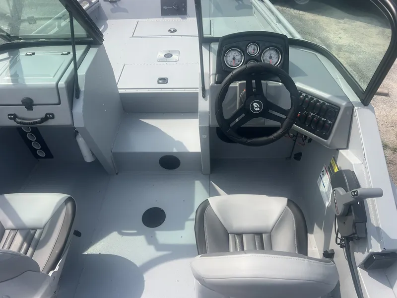 Slide: The Image of The image shows the cockpit of a G3 Sportsman 2100-CATFISH boat. It features gray seats and a modern dashboard with multiple gauges and switches. - 5