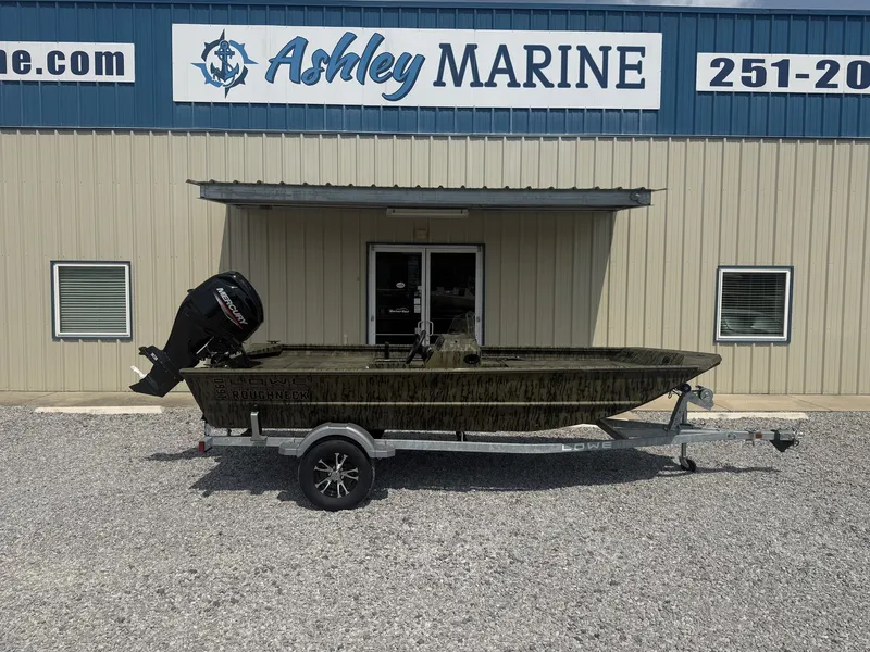 The Image of 2027 Lowe Roughneck 1650SC parked on a trailer in front of a marine shop. - 1