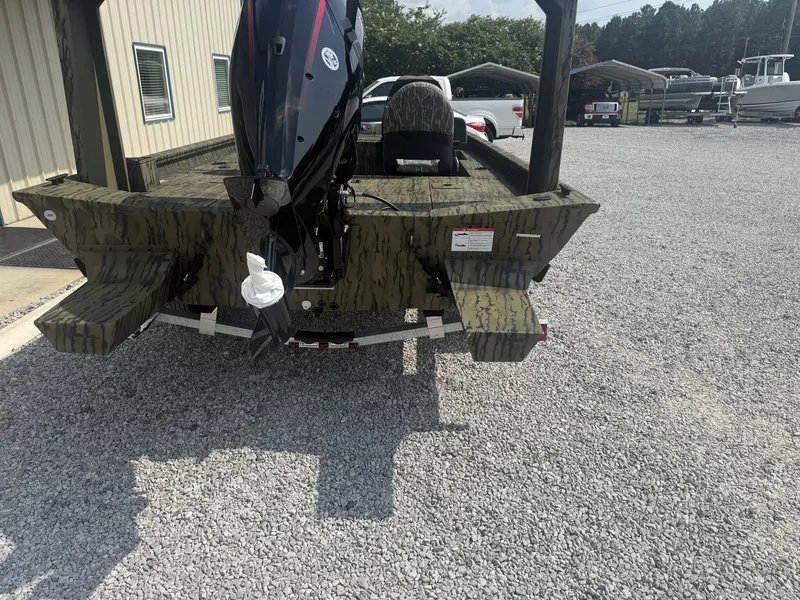 Slide: The Image of A 2027 Lowe Outlet 20-CATFISH boat on a gravel lot. The outboard motor is visible. - 4