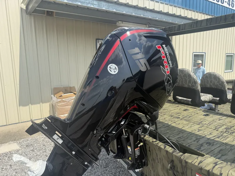 Slide: The Image of An outboard motor labeled "115 Pro XS" is mounted on a boat. - 5