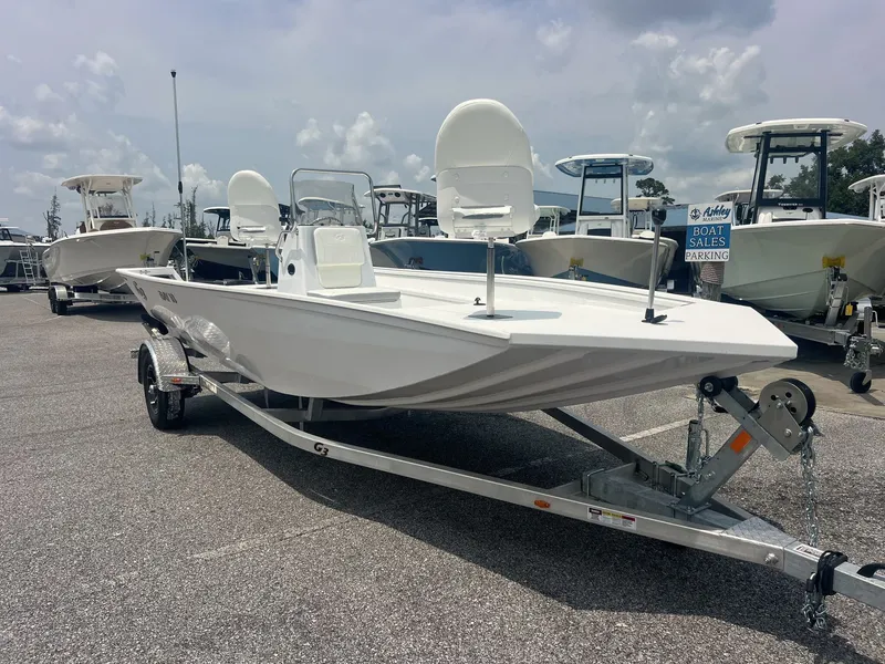 The Image of A white 2026 G3 Bay 18 boat sits on a trailer in a parking lot. - 1