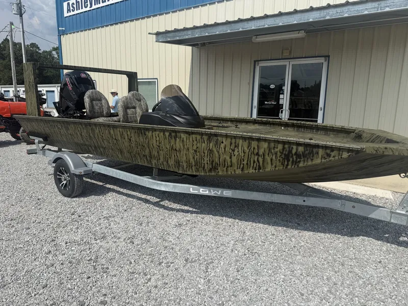 Slide: The Image of A 2027 Lowe Outlet 20-CATFISH boat on a trailer in front of a building. - 3