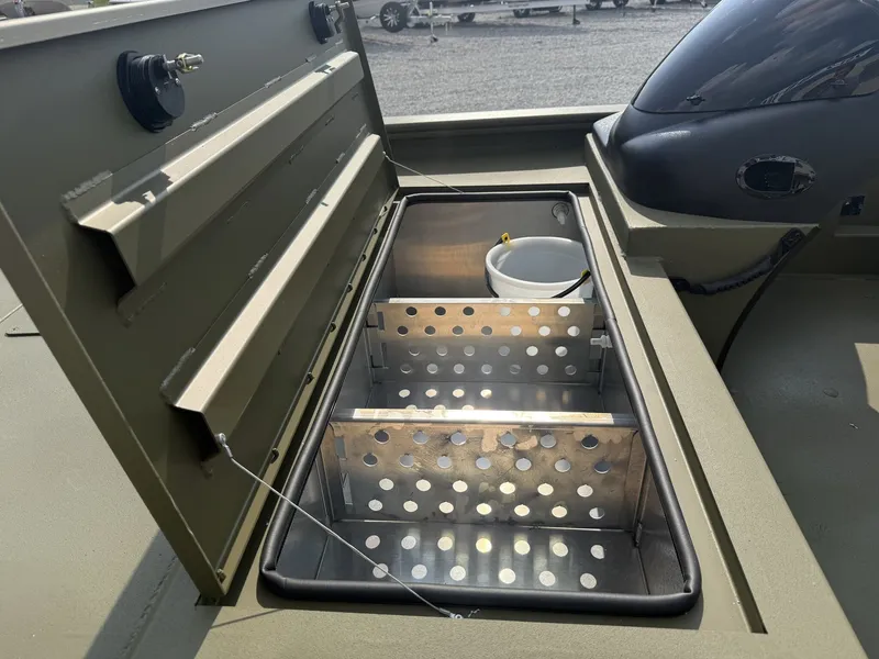 Slide: The Image of An open storage compartment with perforated metal dividers and a bucket inside. - 4